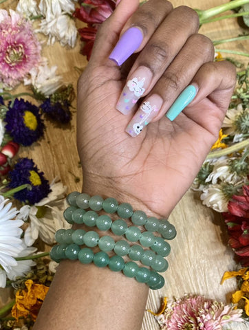 Green Aventurine resonates with the Heart Chakra. It helps us to see beyond unhealthy thoughts to love ourselves and others. Self-love brings us into tune with our divine purposes. It helps to open up our heart chakras to love. Shop Green Aventurine bracelets.