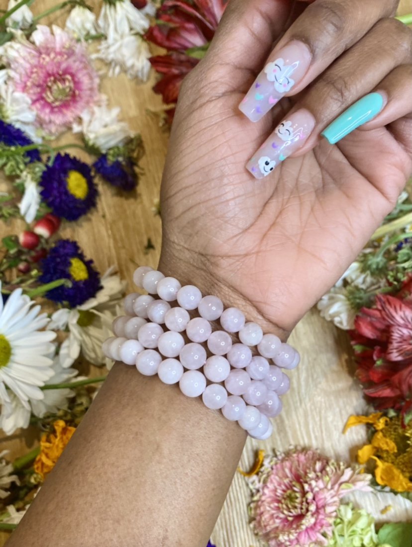 Rose Quartz bracelet pictured. Rose Quartz is a gem for universal love. It helps us to see beyond unhealthy thoughts to love ourselves and others. 