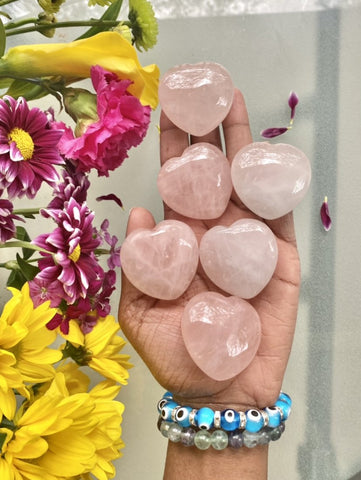 Rose Quartz hearts, or Rose Quartz crystals in the shape of a heart. Rose Quartz helps us to manifest love in all of its forms: love of humanity, self-love, familial love, romantic love, etc.