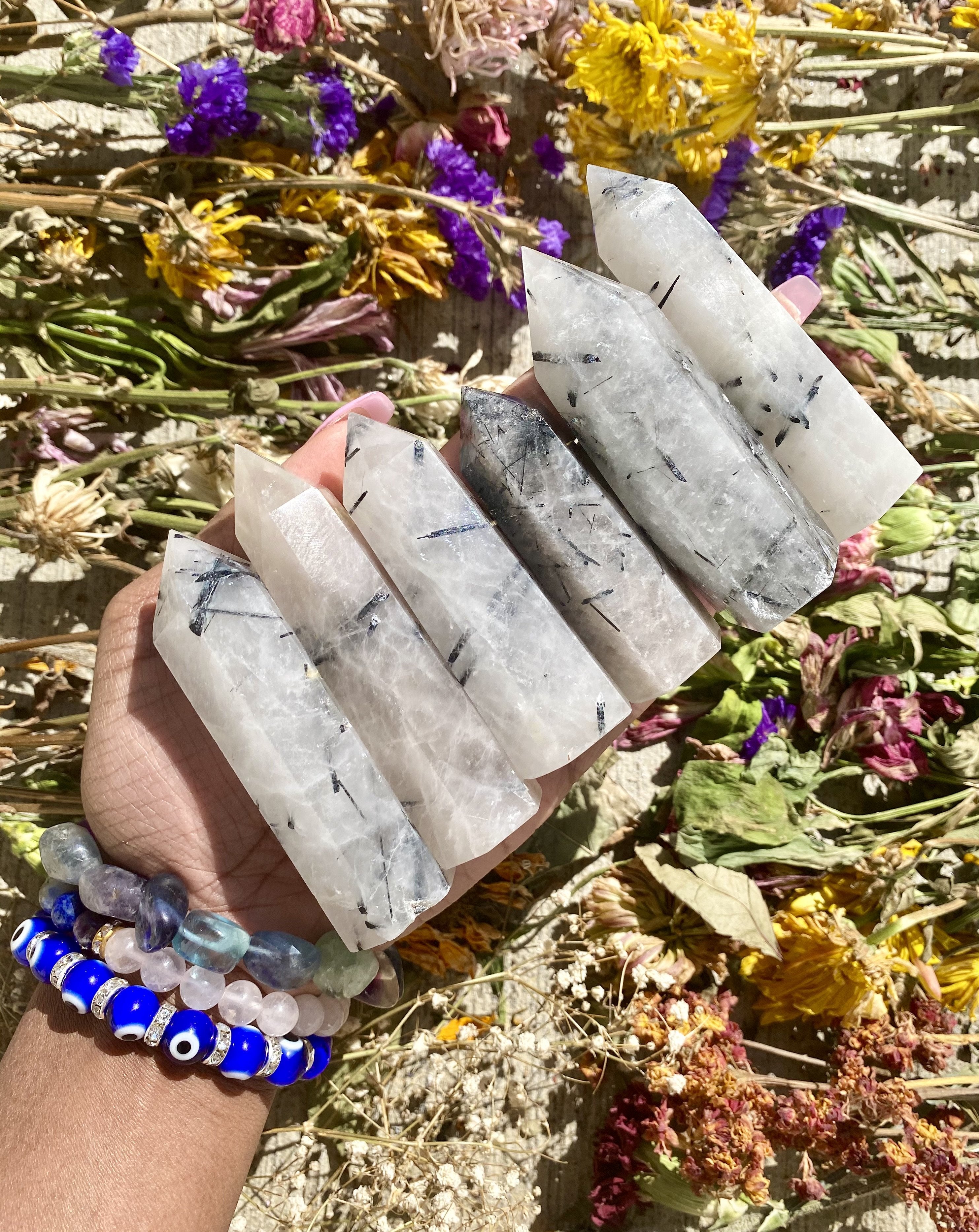 Tourmalinated Quartz is a combination of - you guessed it - Quartz and Tourmaline!  Tourmalinated Quartz activates the Root Chakra and helps us to feel grounded. It helps to harmonize our bodies and souls so that we may focus on the present moment. It also helps in maintaining stability in emotions and feelings.  Shop Tourmalinated Quartz Towers.