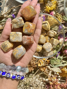 Crazy Lace Agate is also associated with the Root Chakra and is a grounding stone. It helps to harmonize our bodies and souls so that we may focus on the present moment. Tumbled Crazy Lace Agate pictured.